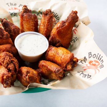 The Boiling Crab - a basket of chicken wings with dipping sauce - Cajun/Creole Near Me - Dallas, Texas