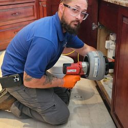 Hers & His Plumbing Services - Felix, clearing a Kitchen sink stoppage.