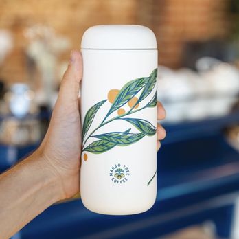 Mango Tree Coffee - a hand holding a coffee mug - Coffee & Tea Near Me - Englewood, Colorado