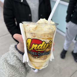 a person holding a cup of ice cream
