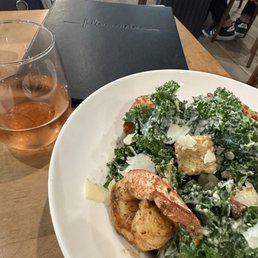 a plate of food and a glass of wine