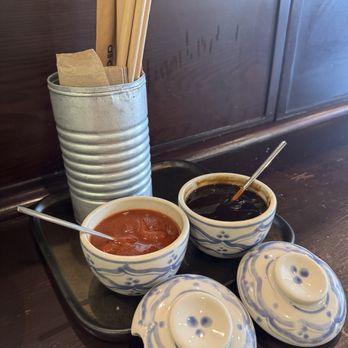 All About Pho - Set up on all the tables. Sriracha (hot sauce), Hoison (sweet sauce), napkins, and chopsticks. - Vietnamese Near Me - Fullerton, California All About Pho - Set up on all the tables. Sriracha (hot sauce), Hoison (sweet sauce), napkins, and chopsticks. - Vietnamese Near Me - Fullerton, California