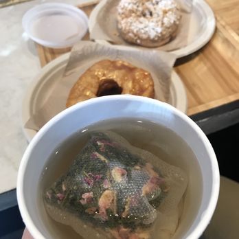 AlimamaTea - jasmine rose tea, creme brulee and cereal donut in background - Desserts Near Me - New York, New York AlimamaTea - jasmine rose tea, creme brulee and cereal donut in background - Desserts Near Me - New York, New York
