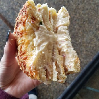 Rich's Bagels - The inside of asiago with orange jalapeno cream cheese - Bagels Near Me - Sandy, Utah Rich's Bagels - The inside of asiago with orange jalapeno cream cheese - Bagels Near Me - Sandy, Utah