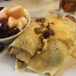 Stuffed crepes fluffy egg, bacon and ham with cheese. Stuffed crepes fluffy egg, bacon and ham with cheese.