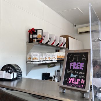 Brandini Toffee - a counter with a sign that says get a free zelff - Chocolatiers & Shops Near Me - Cabazon, California