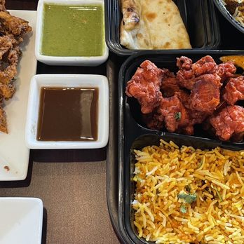 Bawarchi Biryanis - Onion pakora (left) and chicken lunch special which included chicken 65, butter chicken, masala rice, naan and a dessert - Indian Near Me - Frederick, Maryland
