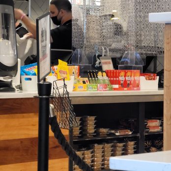 Lebanese Taverna - a man preparing food at a counter - Middle Eastern Near Me - Silver Spring, Maryland