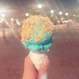 a person holding an ice cream cone