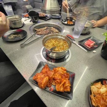 KPOT Korean BBQ & Hot Pot - a man eating - Korean Near Me - Webster, Texas KPOT Korean BBQ & Hot Pot - a man eating - Korean Near Me - Webster, Texas