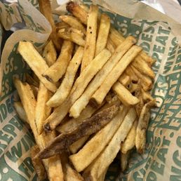 a basket of french fries on a table a basket of french fries on a table