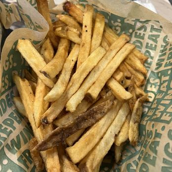 Wingstop - a basket of french fries on a table - Chicken Wings Near Me - Orlando, Florida Wingstop - a basket of french fries on a table - Chicken Wings Near Me - Orlando, Florida