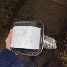 a person holding a box of food