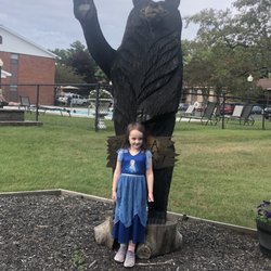 Whispering Pines Apartments & Townhouses - Our girl posing with the bear by the pool after we were approved.