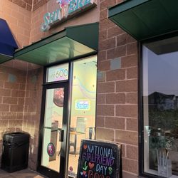Outside with their sign