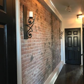 Reliable Team Builders - hallway--they exposed the brick then built a frame around it like a picture - General Contractors Near Me