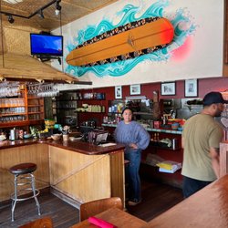 Hula's Island Grill - Surfboard over bar