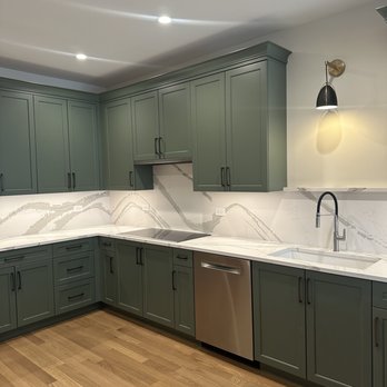 Metro Design Build - a kitchen with green cabinets - Interior Design Near Me