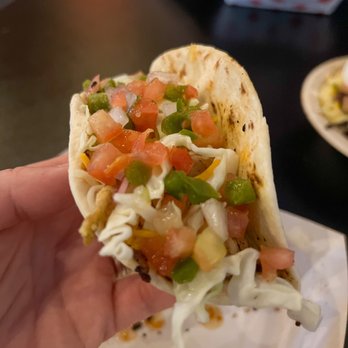 H3SH3R BBQ - a hand holding a taco - Food Trucks Near Me H3SH3R BBQ - a hand holding a taco - Food Trucks Near Me