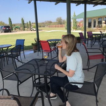 Pemberton Cellars Winery - a woman drinking a glass of wine - Wineries Near Me - Granbury, Texas
