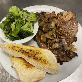 Denny's - T T-Bone Steak with mushrooms and grilled onions! Steamed broccoli! - A meal featuring a T-bone steak topped with sautéed mushrooms and grilled onions, served with steamed broccoli and toasted bread slices. - American Near Me - Tye, Texas