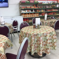 One Stop Food Store - Tables and chairs in the convenience store