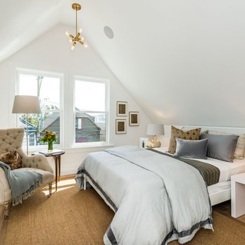 Achill Beg Construction - a bedroom with a bed and a chair - General Contractors Near Me - San Francisco, California Achill Beg Construction - a bedroom with a bed and a chair - General Contractors Near Me - San Francisco, California