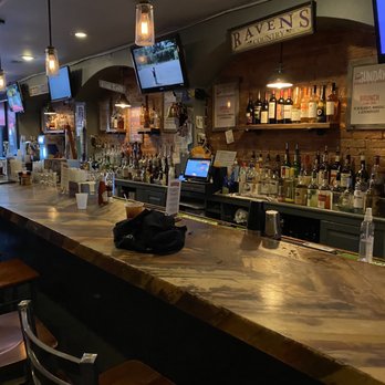 Alexander's Tavern - a bar with people sitting at the bar - Bars Near Me - Baltimore, Maryland