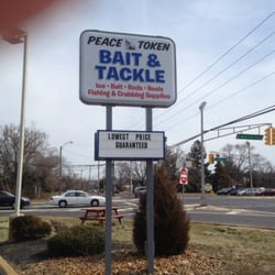 Peace Token Fishing Tackle - Sign in parking lot indicating business name and lowest price guarantee