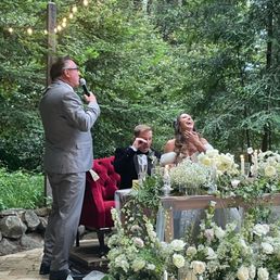Sweetheart table set up with a crying groom and happy bride