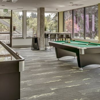 Samm - The Parlor is a community club room with a gourmet kitchen, 75" TV, pool table, shuffleboard, corn-hole, ping-pong, and more! - Apartments Near Me - Sammamish, Washington