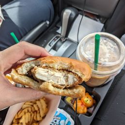 ows a person holding a sandwich and french fries ows a person holding a sandwich and french fries
