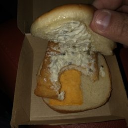 a hand holding a hot dog in a box a hand holding a hot dog in a box