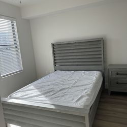 Queen size bed with night stand.