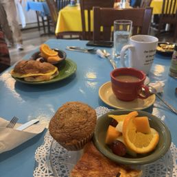 Quiche with fruit and muffin.  Croissant with smoke bacon.