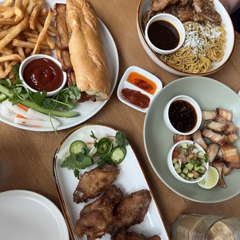 An An - Top left - pork belly banh mi Top right - katsu garlic noodles Bottom left - chicken wings Bottom right - pork belly bites - Vietnamese Near Me - Portland, Oregon An An - Top left - pork belly banh mi Top right - katsu garlic noodles Bottom left - chicken wings Bottom right - pork belly bites - Vietnamese Near Me - Portland, Oregon
