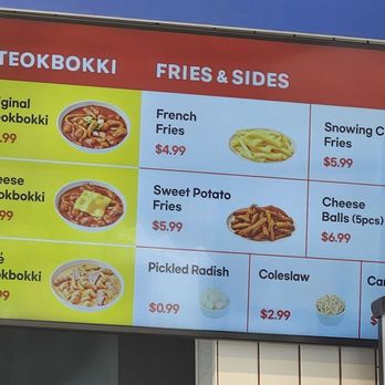 Two Box - The menu board lists different Tteokbokki dishes such as Original, Cheese, and Rose Tteokbokki, with prices ranging from $16.99 to $18.99. It also offers fried sides including French Fries, Sweet Potato Fries, and Cheese Balls, with prices from $4.99 to $6.99. Additional items like Pickled Radish, Coleslaw, and a Can of Soda are also shown with their respective prices. The board is divided into sections with images of some dishes for visual reference. - Korean Near Me - Englewood, New Jersey