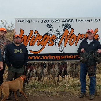 Wings North - four men and a dog standing in front of a sign - Bars Near Me - Pine City, Minnesota Wings North - four men and a dog standing in front of a sign - Bars Near Me - Pine City, Minnesota