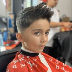 Edge Barbershop - Alfredo E's textured fohawk with a bald lowfade