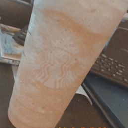a drink in a plastic cup on a table a drink in a plastic cup on a table