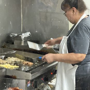 Quickway Shopping - a woman preparing food in a kitchen - Convenience Stores Near Me - Fort Worth, Texas