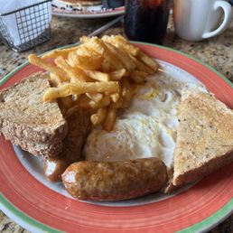 2 eggs over medium, sausage, French fries and 7 grain bread. 2 eggs over medium, sausage, French fries and 7 grain bread.