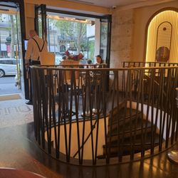 Café Louise - Circular steps leading to the floor below.