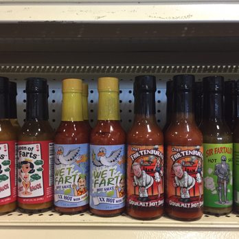 Peppers - a row of hot sauces on a shelf - Specialty Food Near Me - Lewes, Delaware Peppers - a row of hot sauces on a shelf - Specialty Food Near Me - Lewes, Delaware