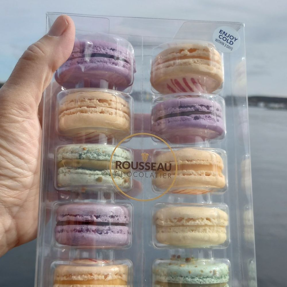 Rousseau Chocolatier - a person holding a box of macarons - Chocolatiers & Shops Near Me - Halifax, Nova Scotia