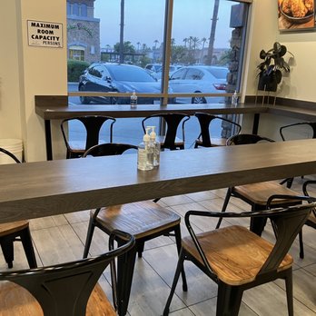Padadak Korean Chicken - Small dining room. (6person table and bar style seating along window and wall). Out of frame to left is a two person table. - Korean Near Me - San Marcos, California Padadak Korean Chicken - Small dining room. (6person table and bar style seating along window and wall). Out of frame to left is a two person table. - Korean Near Me - San Marcos, California