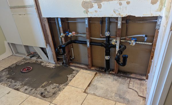 bathroom rough plumbing - we moved the toilet closet flange and installed drains and water service for a double lavatory sink.
