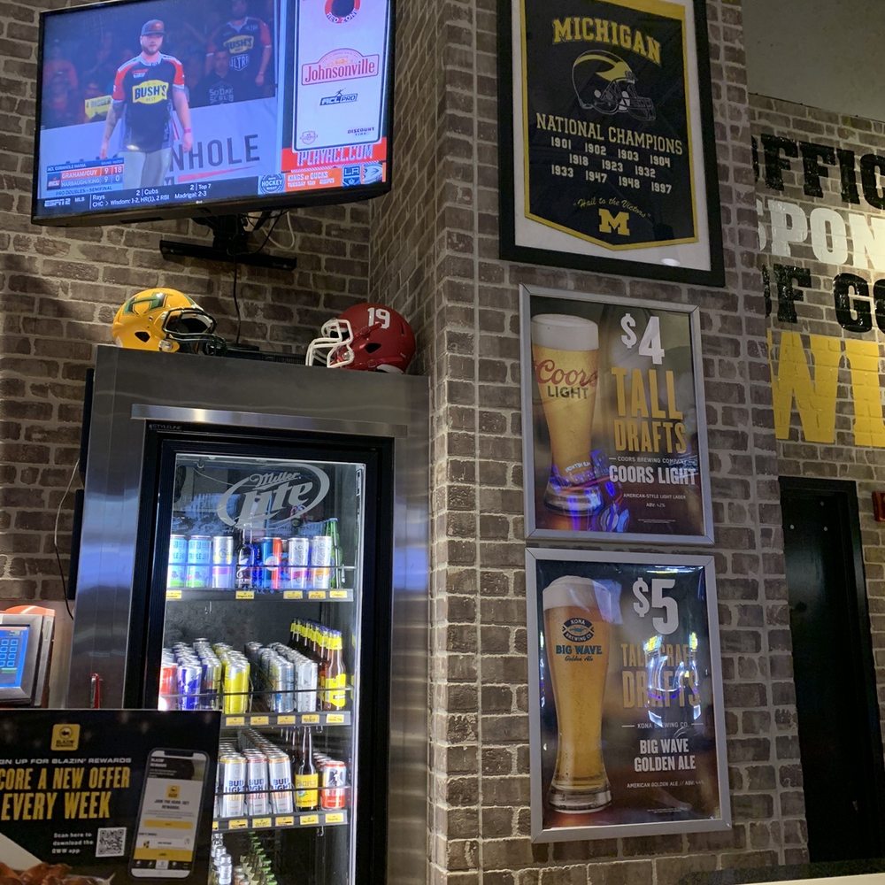 Buffalo Wild Wings - a brick wall with a beer cooler - Chicken Wings Near Me - Brighton, Michigan Buffalo Wild Wings - a brick wall with a beer cooler - Chicken Wings Near Me - Brighton, Michigan