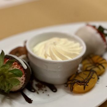 Hugo's Cellar - Dessert included with entree, chocolate strawberries, mango, and fig with whipped cream - American Near Me - Las Vegas, Nevada