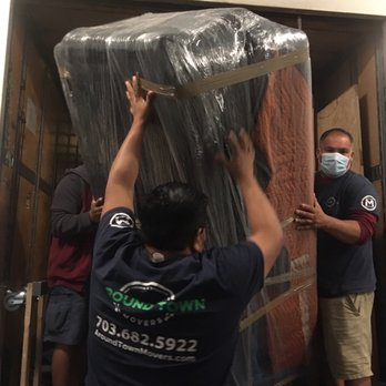 Around Town Movers - Removing a carefully wrapped sofa from the truck - Movers Near Me - Sterling, Virginia